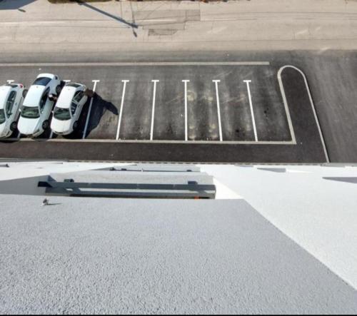 a row of parked cars in a parking lot at Apartman Aurora in Modriča