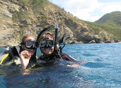 two people in the water on a boat at Ocean Lovers Taganga - PADI Dive Center & Hostel in Taganga