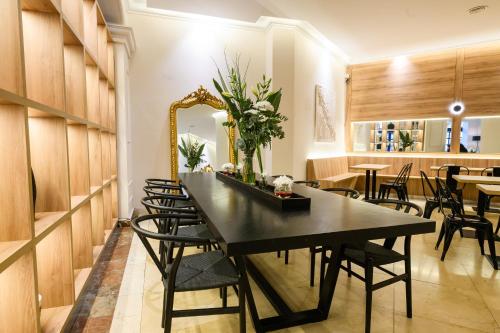 a dining room with a black table and chairs at Midtown Boutique Hotel in Buenos Aires