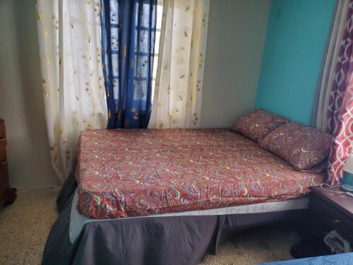 a small bed in a room with curtains at Bayview Luxury Retreat 