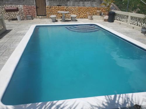 a large swimming pool with a blue poolvisor at Bayview Luxury Retreat 