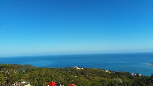a view of the ocean from the top of a hill at Bayview Luxury Retreat 