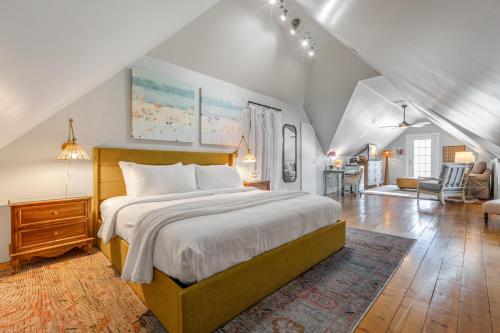 a bedroom with a large bed and a living room at ARIA at Azul Mansion Key West in Key West