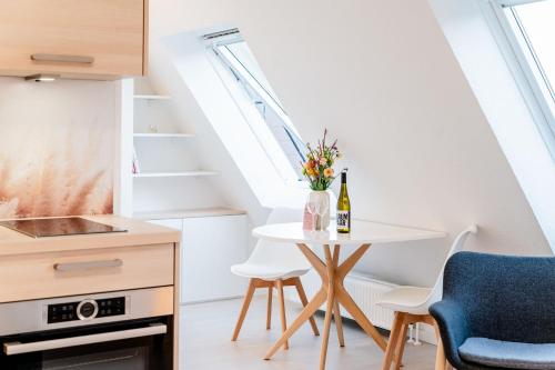 a small kitchen with a table and a bottle of wine at Pure Hygge in Harrislee