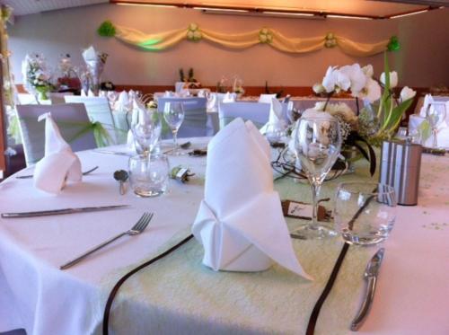 a table with a white table cloth with glasses and napkins at Holiday Inn Lille Ouest Englos by IHG in Englos