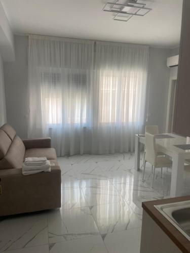 a living room with a couch and a table at Zerbi House in Reggio Calabria