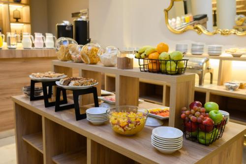 a buffet with bowls of fruit and plates of food at Midtown Boutique Hotel in Buenos Aires