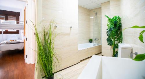 a bathroom with a shower and a sink and plants at Luxury Signature Apartment with FREE Parking - Malaga in Málaga