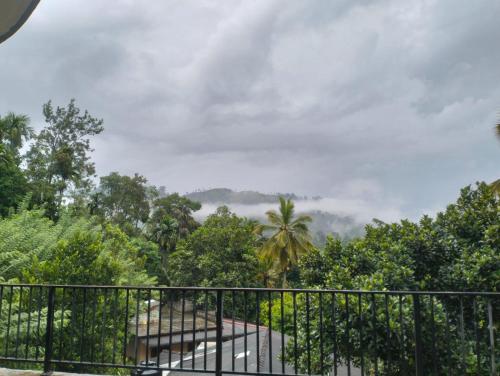 a view from the balcony of a house with a fence at Ceylon Elegant in Ella