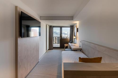 a corridor of a hotel room with a view of the mountains at Victoria Hotel & Residence in Villars-sur-Ollon
