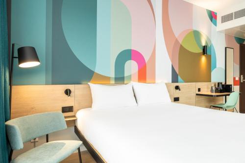 a room with two beds and a table and chairs at B&B HOTEL Brussels Airport in Diegem