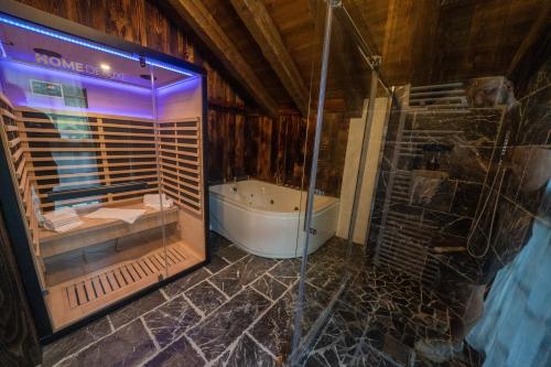 a bathroom with a shower and a tub and a glass shower at Eirl DOLOMITES Retreat Sappada in Sappada