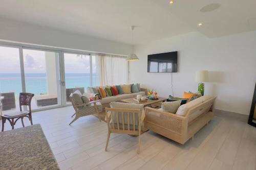 a living room with a couch and a table at Beachfront FL21 Con Tina Aquarella in La Puntica de Juan Dolio