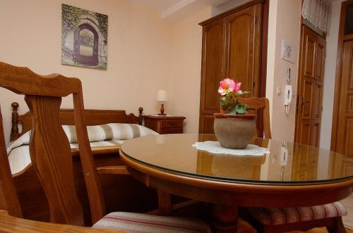 a room with a table with a vase of flowers on it at Palace Stafileo in Trogir