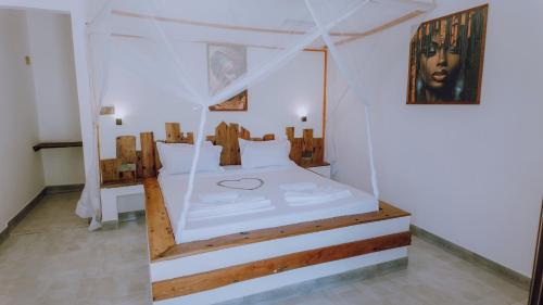 Postel nebo postele na pokoji v ubytování Jambo Resort by Mambo Hotels