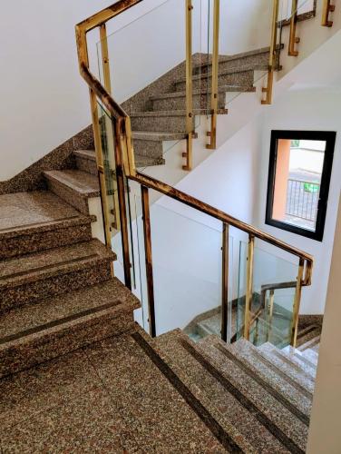 a staircase in a home with wooden railings and a window at Venice Luxury Apartment in Venice