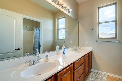 a bathroom with two sinks and a large mirror at Desert Bliss Heated Pool Power Ranch Perks in Queen Creek