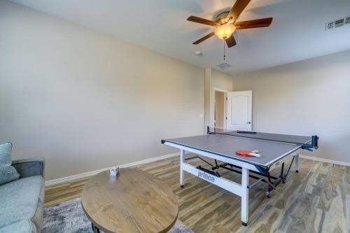 a ping pong table in a living room with a ceiling fan at Desert Bliss Heated Pool Power Ranch Perks in Queen Creek