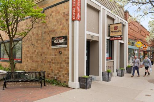 a bench in front of a brick building at The Roost 16 on Front 2BR Private Hot Tub Patio in Traverse City