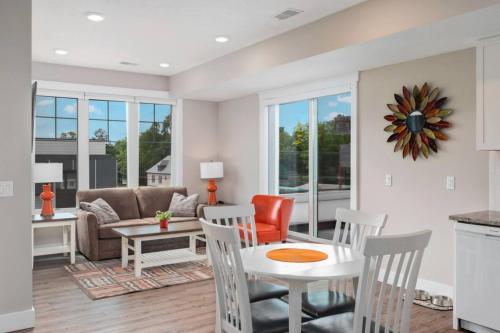 a living room with a table and a couch at The Perch 14 on Front 2BR Private Hot Tub Patio Downtown Walks in Traverse City