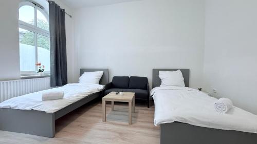 En eller flere senge i et værelse på Business-Apartments Neumünster Zentrum
