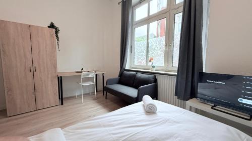 En eller flere senge i et værelse på Business-Apartments Neumünster Zentrum
