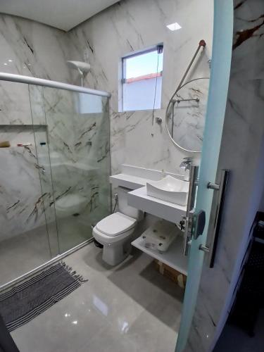 ein Badezimmer mit Dusche, Toilette und Waschbecken in der Unterkunft Hospedaria Transcendental - Mucugê-BA in Mucugê