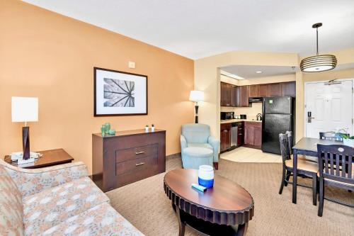 a living room with a couch and a table at Hot Tub & Pool Condo Near to Universal in Orlando