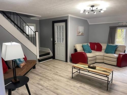 a living room with a couch and a table at N Lake Ontario 3BR Home Near Beach Seabreeze in Rochester