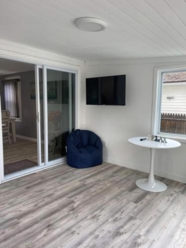 a living room with a blue chair and a table at N Lake Ontario 3BR Home Near Beach Seabreeze in Rochester
