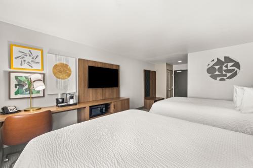 a hotel room with two beds and a tv at Holiday Inn Austin North by IHG in Round Rock