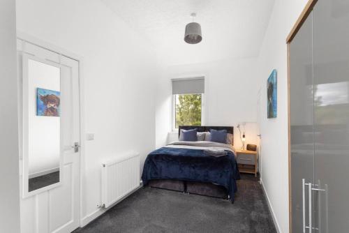 un dormitorio con una cama y una ventana en Stylish Stay in Inverkeithing., en Fife