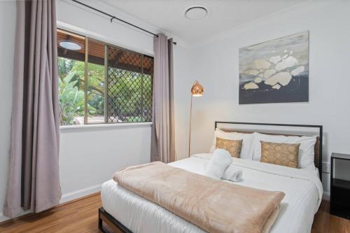 a bedroom with a bed with a teddy bear on it at Nature Escape Acreage Forest Life and Pet Friendly in Boronia Heights