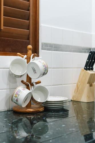 a group of cups and plates on a counter at Nature Escape Acreage Forest Life and Pet Friendly in Boronia Heights