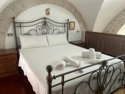 a bedroom with a large white bed with towels on it at Bella Vita Apartment in Ruvo di Puglia