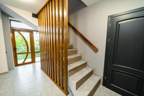 a staircase in a house with a black door at Villa Caza in Chişinău