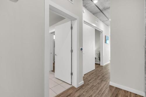 an empty hallway with white walls and wood floors at Tropicana Field 1 Bed in Downtown With Free Parking in St Petersburg