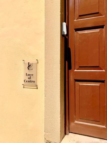 a door with a sign that readslance of caution next to it at Luce al Centro in Corfu