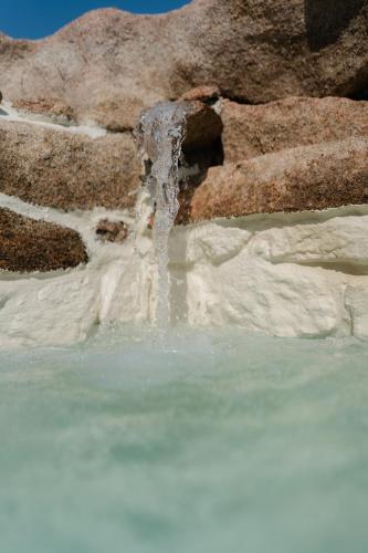 a waterfall in the middle of a body of water at A Malgrana - Tente lodge hébergement insolite in Coti-Chiavari