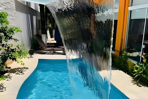 a water feature in a backyard with a swimming pool at CURTA! |135| Casa | Piscina | Prox. Roda Gigante in Cabeçudas