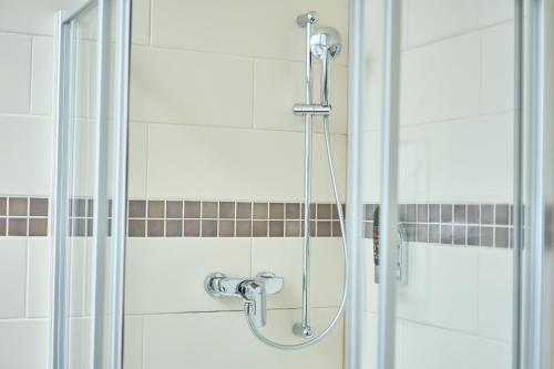 a shower with a glass door in a bathroom at eXo Boutique Hotel Mannheim - by SuperFly Hotels in Mannheim