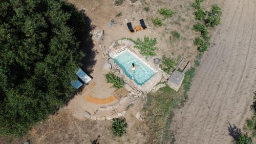 an aerial view of a swimming pool next to the ocean at A Malgrana - Tente lodge hébergement insolite in Coti-Chiavari