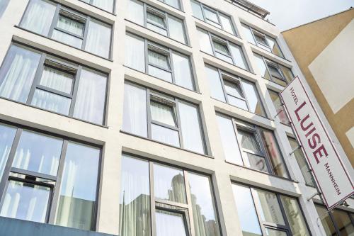 a building with windows and a sign in front of it at eXo Boutique Hotel Mannheim - by SuperFly Hotels in Mannheim