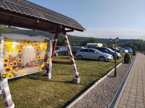 a table with sunflowers on it in a park at Casa Jazmin Covasna in Covasna