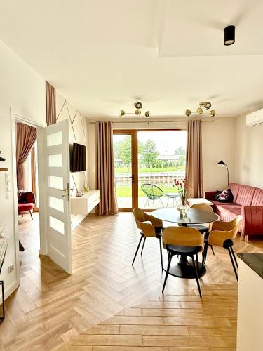 a living room with a table and a couch at Apartament River in Pisz
