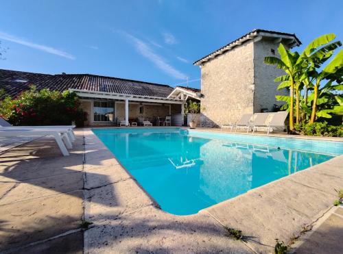 a swimming pool in front of a house at Suite Antonin in La Sauvetat-sur-Lède
