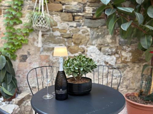 a black table with a bottle of wine and a lamp at Il Giardino Nascosto in Trieste