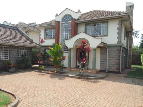 a house with a brick driveway in front of it at Runda Paradise1 in Nairobi