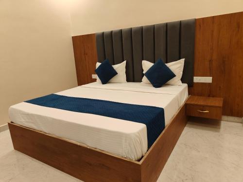 Un dormitorio con una cama grande con almohadas azules. en Hotel Ramayan Elite 2 KM Shree Ram Ji Mandir and Free Pickup From Ayodhya Dham Railway Station, en Ayodhya