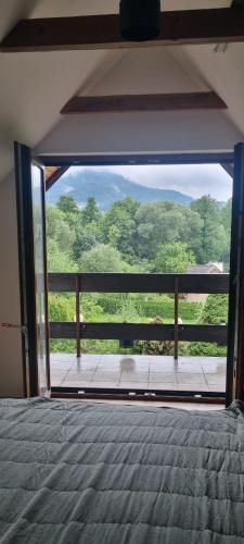 a room with a view of a field through a glass door at dziupla in Górki Wielkie